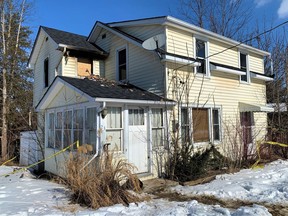 Officers with the Norfolk OPP raced into this house on Sylvia Street in Waterford Saturday during a fire emergency. They emerged with a seriously injured senior who was incapacitated on the second floor. The victim was air-lifted to hospital in Toronto with serious injuries. – Monte Sonnenberg