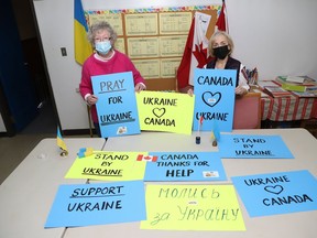 Sonia Peczeniuk, left, and Valentyna Stasiv display some of the placards that have been made for the Stand with Ukraine rally in Sudbury, Ont. on February 6, 2022 at noon outside near St. Mary's Ukrainian Catholic Church. John Lappa/Sudbury Star/Postmedia Network