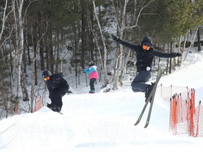A skier and snowboarders perform acrobatics at Adanac Ski Hill in Sudbury, Ont. on Thursday February 3, 2022. Hours of operation, fees and up-to-date hill conditions are available at www.greatersudbury.ca/play/ski-hills. John Lappa/Sudbury Star/Postmedia Network