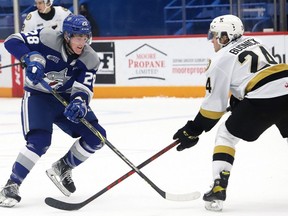 Marc Boudreau, left, of the Sudbury Wolves, attempts to skate past Thomas Budnick, of the Kingston Frontenacs, during OHL action at the Sudbury Community Arena in Sudbury, Ont. on Friday February 4, 2022. John Lappa/Sudbury Star/Postmedia Network