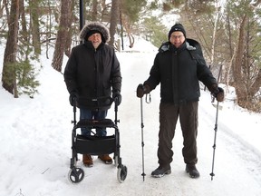 James Hicks, left, and Bob Wallace go for a walk at Bell Park in Sudbury, Ont. on Thursday February 10, 2022. John Lappa/Sudbury Star/Postmedia Network