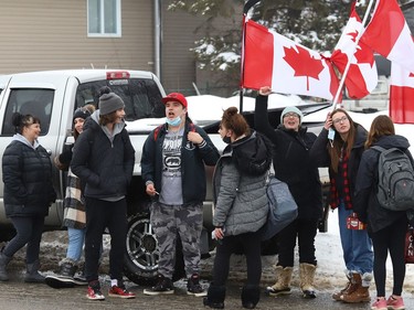 Demonstrators take part in a protest of COVID-19 mandates near the entrance to Lo-Ellen Park Secondary School in Sudbury, Ont. on Friday February 11, 2022. John Lappa/Sudbury Star/Postmedia Network
