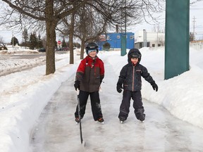 Adrien Sonier, 9, left, and his brother, Cedrik, 6, skate around the ice track at the Sixth Avenue rink in Lively, Ont. on Thursday February 17, 2022. John Lappa/Sudbury Star/Postmedia Network
