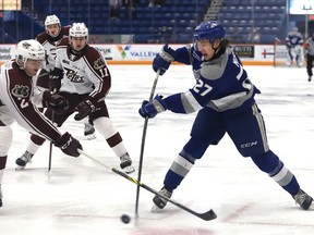 Quentin Musty, right, of the Sudbury Wolves, attempts to fire the puck past Samuel Mayer, of the Peterborough Petes, during OHL action at the Sudbury Community Arena in Sudbury, Ont. on Thursday February 17, 2022. John Lappa/Sudbury Star/Postmedia Network