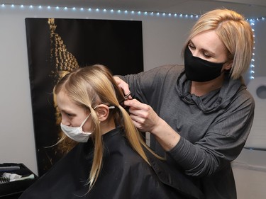Hairstylist Chenelle Desjardins cuts 10-year-old Jackson Jost Noob's hair in Sudbury, Ont. on Friday February 18, 2022.