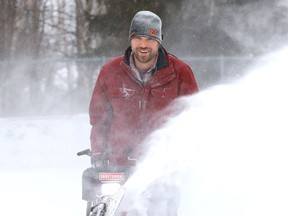 Chad Corson clears snow off the rink at the Oja Sports Complex in Naughton, Ont.
