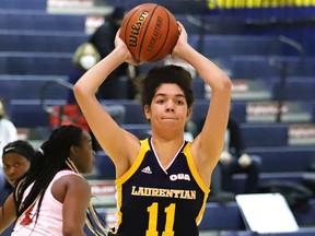 Aneisha Rismond, of Laurentian Voyageurs, dishes off the basketball during OUA basketball action against the York Lions at Laurentian University in Sudbury, Ont. on Thursday February 24, 2022. York defeated Laurentian 70-52. John Lappa/Sudbury Star/Postmedia Network