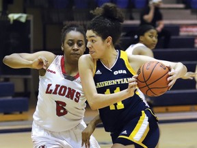 Aneisha Rismond, right, of Laurentian Voyageurs, drives to the basket against Cyanna King, of York Lions, during OUA basketball action at Laurentian University in Sudbury, Ont. on Thursday February 24, 2022. York defeated Laurentian 70-52. John Lappa/Sudbury Star/Postmedia Network