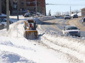 A city sidewalk plow clears snow from a sidewalk on Paris Street in Sudbury, Ont. on Thursday February 24, 2022.