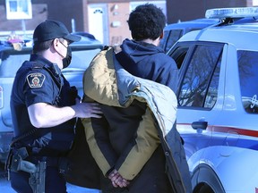 Greater Sudbury Police arrest an individual Friday in the Ryan Heights area. Three people have now been charged in what is described as a forcible confinement.