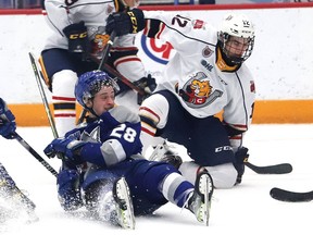 Marc Boudreau, left, of the Sudbury Wolves, is knocked to the ice during OHL action against the Barrie Colts at the Sudbury Community Arena in Sudbury, Ont. on Friday February 25, 2022. John Lappa/Sudbury Star/Postmedia Network