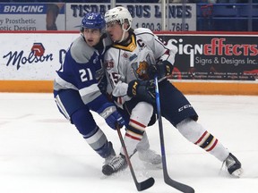 Alex Pharand, left, of the Sudbury Wolves, and Brandt Clarke, of the Barrie Colts, battle for position during OHL action at the Sudbury Community Arena in Sudbury, Ont. on Friday February 25, 2022. The Wolves won 8-5. John Lappa/Sudbury Star/Postmedia Network