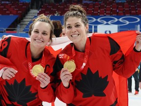 BEIJING, CHINA - FEBRUARY 17: (L-R) Gold medal winners Marie-Philip Poulin #29 and Rebecca Johnston #6 of Team Canada celebrate during the medal ceremony after the Women's Ice Hockey Gold Medal match between Team Canada and Team United States on Day 13 of the Beijing 2022 Winter Olympic Games at Wukesong Sports Centre on February 17, 2022 in Beijing, China.