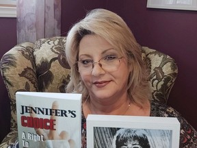 Petrolia author, publisher and entrepreneur Dawn Stilwell holds a copy of her recent book, Jennifer's Choice: A Right to Die Story, as well as a picture of her late sister Jennifer Ellis. Handout/Sarnia This Week