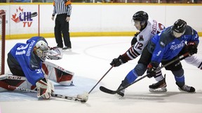 Sam Sedley attempts to eliminate Sasha Pastukov as Nick Chenard deflects the puck in the second period as the Owen Sound offense hosts the Guelph Storm inside the Harry Lumley Bayshore Community Center on Saturday February 26, 2022. Greg Cowan / The Sun Times