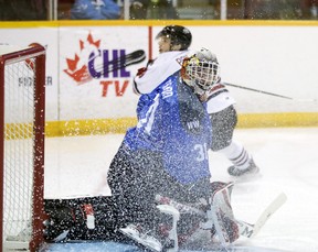 Nick Chenard looks for the rebound through a curtain of shards of ice in the second period as the Owen Sound offense hosts the Guelph Storm inside the Harry Lumley Bayshore Community Center on Saturday February 26, 2022. Greg Cowan / The Sun Times