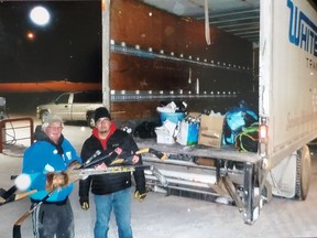 Volunteers loaded donated hockey and skating equipment into a Whitecourt Transport truck.