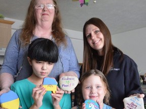 1st Wiarton Sparks and Brownies Unit 1090 guiders Brenda Bamford, back left, and Stacie Fretz, with their daughters Cathy Bamford, 9, and Abbey Fretz, 5, show some of the rocks they painted on Tuesday, March 1, 2022, as they kick off a fundraiser for Ukrainian humanitarian relief.