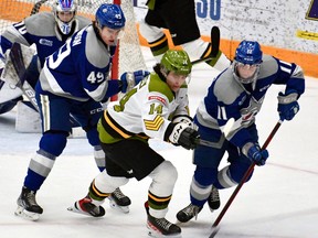 Dalyn Wakely of the visiting North Bay Battalion competes Sunday with Payton Robinson and Landon McCallum of the Sudbury Wolves as goaltender Mitchell Weeks watches. The teams meet in Ontario Hockey League action Thursday night at a full-capacity Memorial Gardens.
Sean Ryan Photo
