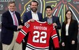 The Chicago Blackhawks management team, from left, Chairman Rocky Wirtz, CEO Danny Wirtz, general manager Kyle Davidson, and president of business operations Jamie Faulkner stand for a photo after naming Davidson as the team's new general manager during an NHL hockey news conference Tuesday, March 1, 2022, in Chicago. Davidson becomes the team's 10th general manager after dropping his interim tag instead of going outside the franchise for new leadership. Davidson has been with the Blackhawks since he joined the organization as a hockey operations intern in 2010.