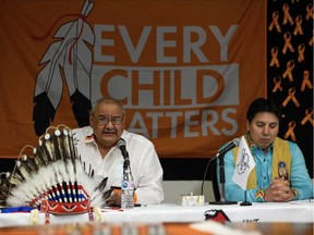 Treaty 8 Grand Chief Arthur Noskey (right) listens while Kapawe'no First Nation Chief Sydney Halcrow speaks about the discovery of 169 potential remains with ground penetrating radar at the former Grouard Mission site in Treaty 8 during a press conference in Edmonton on Tuesday, March 1. IAN KUCERAK/Postmedia