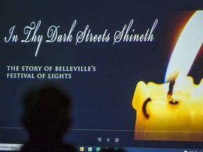 An audience member watches a pre-screening of In 'Thy Dark Streets Shineth: The Story of BellevilleÕs Festival of Lights' which will premiere at this year's Belleville Downtown DocFest. Wednesday in Belleville, Ontario. ALEX FILIPE
