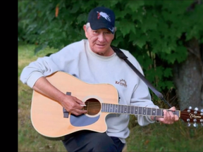 Frank 'Bojo' Boyer plays his Takamini guitar at home in Rankin Reserve.