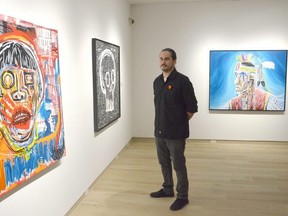 Brent Henry with three of his works, from left, Still Missing, Bones Don't Lie, and Survivor #3 at the Tom Thomson Art Gallery in Owen Sound on Friday, March 4, 2022.