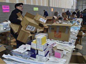 Volunteers packing boxes of emergency response supplies trying to fill a plane, that will be airlifted to the Ukraine, at a warehouse in west in Edmonton, March 4. The Ukrainian Canadian Congress Alberta Provincial Council has joined forces with Firefighter Aid to Ukraine with this response. ED KAISER/Postmedia