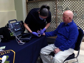 Denis Champagne gets his blood glucose level checked by paramedic Stephanie Asselin, Saturday, as part of the Paramedics and Pancakes event at the Davedi Club in North Bay.
PJ Wilson/The Nugget