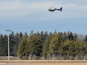 A low-flying Huron-Perth search rescue helicopter is visible just east of Mitchell Sunday afternoon, March 6, as fire departments search the tributaries of Whirl Creek after reports of a child fell through ice around 10:30 a.m. ANDY BADER/POSTMEDIA NETWORK