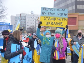 Demonstrators gather outside the St. Mary’s Ukrainian Catholic Church on Sunday to show support for Ukraine as Russian troops continued to advance on key cities.