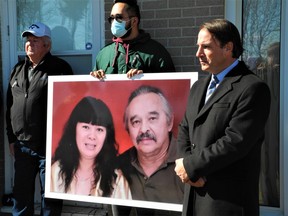 Simcoe lawyer Michael Smitiuch, right, played host to a second news conference Tuesday in connection with the police shooting of Norfolk gunsmith Rodger Kotanko Nov. 3, shown here in a large photo with his wife Jessie Kotanko. – Monte Sonnenberg