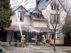 Firefighters work to put out hotspots the morning of Feb. 17 at this Elgin Street home in Wallaceburg that caught fire around 2 a.m., resulting in the death of three people. Ellwood Shreve/Postmedia