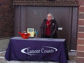 Hazel Anaka of Babas and Borshch accepted public donations on behalf of Lamont County and the Town of Lamont at the Ukraine Flag raising event on March 4, 2022. Lamont County Reeve Diduck has challenged surrounding municipalities to donate to humanitarian aid. Photo Supplied by Lamont County.