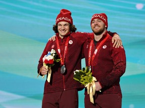 Silver medallists Mac Marcoux and guide Tristan Rodgers of Team Canada celebrate with their medals during the Para Alpine Skiing Men's Downhill Vision Impaired Medal Ceremony during Day One of the Beijing 2022 Winter Paralympics at Yanqing Para Medals Plaza on March 5 in Yanqing, China.