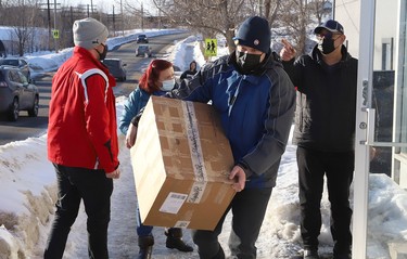 Volunteers from the local Ukrainian community move supplies to a waiting van at the Ukrainian National Federation hall in Sudbury, Ont. on Thursday March 10, 2022. Medical and other supplies are being delivered to Toronto, and then shipped overseas to support Ukrainians. John Lappa/Sudbury Star/Postmedia Network