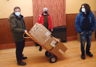 Volunteers from the local Ukrainian community move supplies to a waiting van at the Ukrainian National Federation hall in Sudbury, Ont. on Thursday March 10, 2022. Medical and other supplies are being delivered to Toronto, and then shipped overseas to support Ukrainians. John Lappa/Sudbury Star/Postmedia Network