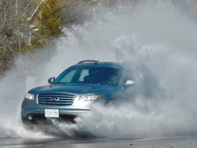 A motorist created a big splash at Dundas Street and Selena Drive in Belleville as their SUV entered a puddle of melting- snow runoff due to warming temperatures this week. Environment Canada said winter conditions will return briefly with snow forecast for late Friday and into Saturday before warmer temperatures return next week. DEREK BALDWIN