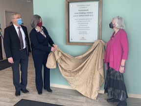Kingston Health Sciences Centre president and CEO Dr. David Pichora, alongside Michelle Chatten Fiedorec of Homestead Land Holdings Foundation and Maggie Daicar, as they unveil a plaque at the Breast Imaging Kingston facility on John Marks Avenue on Thursday.