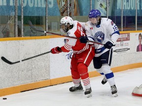 Greater Sudbury Cubs forward Ben Harris (16) battles for position with Elliot Lake Red Wings defenceman Cameron Dial (77) during first-period NOJHL action at Gerry McCrory Countryside Sports Complex in Sudbury, Ontario on Thursday, March 10, 2022.