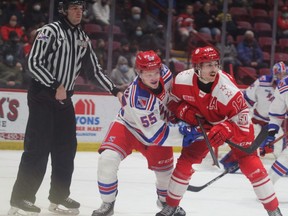 Kitchener Rangers forward Reid Valade and Soo Greyhounds forward Tye Kartye battle for puck possession after a first period face off in Friday night OHL action at the downtown rink. The Hounds scored three second-period goals in a 5-3 win over the Rangers.