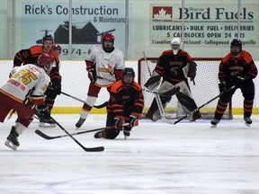 #25 Jesse McIntyre loads up a shot from the point, waiting to be tipped by #22 Trent Michie. Riley Randell picture