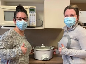 Durham Medical Clinic manager Rachel Parrott, left, and nurse Jessica Hartman pose with a pot of cream of broccoli soup donated by the "Soup Lady."