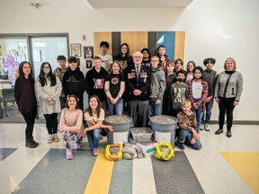 Mrs. Osmachenko's Grade 6 class was the winner of the initiative to raise money for the Legion’s Poppy fund. They collected the most tabs from cans and will receive a pizza lunch as their prize. Mrs Rorke (Vice principal), and Bob Collins (Past President Royal Canadian Legion High River) were also present for the photo.