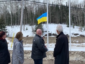 Members of East Ferris council and Peter Chirico, president of the North Bay and District Chamber of Commerce watch Friday as the Ukrainian flag is raised at the East Ferris Community Centre.