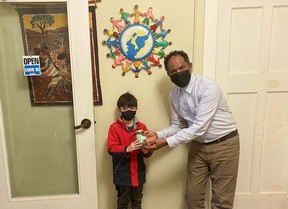 Stratford seven-year-old Adam Gordon recently raised more than $40 through his lemonade stand, which he donated to the Multicultural Association of Perth Huron in support of incoming Ukrainian refugees who will soon be settling in Huron and Perth counties.  Pictured, Gordon delivers the money he raised to association executive director Dr. Gezahgn Wordofa.  (Submitted photo)