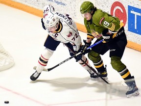 Kyle McDonald of the North Bay Battalion and the visiting Barrie Colts' Nathan Allensen battle for puck possession in Ontario Hockey League action Sunday. The Battalion plays host to the Hamilton Bulldogs on Thursday night.
Sean Ryan Photo