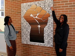 Rainat Salako, left, and Omobola Agboola explain the message behind the mural they created at Chippewa Secondary School on the power of education to eradicate racism.
PJ Wilson/The Nugget
