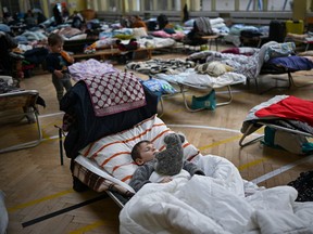 Women and children, who have fled war-torn Ukraine, rest Monday in a shelter set up in a primary school close to the Ukrainian border in Przemysl, Poland. Nearly two-thirds of the more than three million people who have fled Ukraine since Russia's invasion last month have come to Poland. There’s still no indication as to when the first wave of people may arrive in Canada.
Jeff J Mitchell/Getty Images